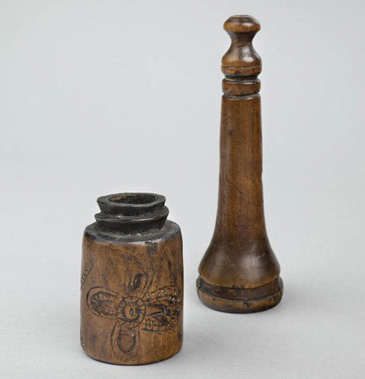 This inkhorn was used to store ink. A quill would be dipped into it before writing on the page. This wooden inkhorn was made and decorated by a craftsman known as a turner. It was built to be portable, with a screw-on lid to keep the ink from drying out or leaking. It could be carried by literate writers to perform some administrative task (like acting as churchwarden). Writers had clear preferences for certain kinds of ink, and many would experiment by making recipes at home.<br />
<br />
There are thousands of printed and manuscript recipes for ink surviving for this period, demonstrating how the practice of its making was often home grown. Although many accounts demonstrate ink being purchased, it is rare to find an actual source for the substance before the mid-seventeenth century (Adrian Johns), and ink for writing was very different to the kind used in printing. It is likely that people bought ink from grocers, stationers, itinerant traders and markets, or made it themselves with ingredients gathered locally or purchased from apothecaries.