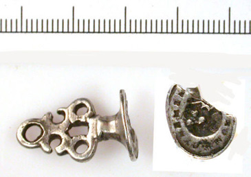 A seal matrix is a metal stamp with a design, used to press into sealing wax and make a seal. Seals both secured and authorised documents. Those of middling status and above, with property, money or official role, would need to seal documents or send letters while managing personal, family or community business. The image impressed in the wax would identify the sender to legitimise the contents. This particular seal has a memento mori inscription around a central image (a skull). Memento mori in Latin translates as remember death or remember you will die.<br />
<br />
At this time there was a widespread culture of memento mori inscriptions and imagery, which reflected commitment to Christian faith as a reminder to meditate on mortality and display hope or trust in a heavenly afterlife. Memento mori imagery could be found on a variety of early modern personal objects, particularly items of jewellery. Rings, in particular, were often gifted to close friends in wills as a remembrance of the deceased person.<br />
<br />
A seal matrix such as this could be carried about the person. A ribbon or strap would be passed through the loop on the handle, and then secured to an item of clothing such as a belt. Such objects served to perform and promote piety; they could help their owner remember the importance of humility and faith while displaying this understanding to others. This would be especially important for middling sorts, who were often invested in charitable acts, and had responsibilities within their local community with regards to governance. As such, they were conscious of their role as models and examples of expected behaviour. This matrix, then, could indicate to those around them their good spiritual and moral standing.