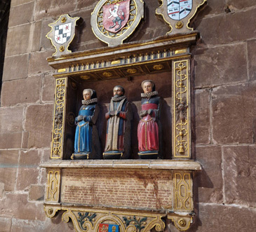 This funeral monument dated 1602 is in Chester cathedral. As the inscription states, it is erected To the memory of that grave and worthy citizen Thomas Greene sometimes Mayor of this Cittie, and he is depicted kneeling with his hands (now missing) together in prayer, flanked by his two wives. The monument shows them as if at prayer in this space of worship. The inscription records that the monument was erected by the executors of his last will and testament, and this posthumous commemoration by executors was common during the period.<br />
<br />
Thomas Greene is remembered for his integritie of lyfe, curtesy, sobriety and facilitie of manners, his constant love unto his frends and bounty to the poore. Having no direct heirs, he left his entire inheritance to the benefit of divers good and charitable uses, and to his frends, kinsfolks and to his bethren the aldermen of this citty. <br />
<br />
This worthy citizen is set up as an example to others, with his public service to the city  sheriff in the year 1551 and mayor in 1563  but also his character and charitable bequests to the benefit of others when he died a tymely deathe at the age of 76 in 1602.