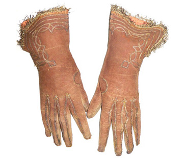 Gloves like this were sometimes practical (e.g. for riding or keeping the hands warm) but more often they were signs of being decently dressed when not engaged in manual labour, and an important part of middling clothings show-off qualities  accessories that allowed men and women to introduce a note of luxury into their dress.<br />
<br />
Gloves were sometimes given as courtship gifts or as new years presents, marked out as special personal items. In Shakespeares <em>Winters Tale</em>, Autolycus is selling Gloves as sweet as damask roses, the word sweet showing that the leather could be perfumed, thus making them a desirable luxury item, but on a small scale  less expensive and flashy than a gown or cloak, for instance (although they could be expensive and highly decorated).<br />
<br />
Middling sitters in portraits are often shown holding gloves as a sign of their status and taste (you will see them elsewhere in this exhibition), and sometimes the authority of their office-holding. These gloves are marked out by their bright colour and embellishment or detailing. 